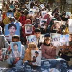 Relatives of missing Pakistanis hold pictures of their loved ones in a demonstration during Human Rights Day in Quetta, the capital of Balochistan province, on December 10, 2018