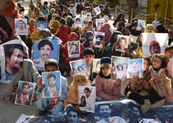 Relatives of missing Pakistanis hold pictures of their loved ones in a demonstration during Human Rights Day in Quetta, the capital of Balochistan province, on December 10, 2018