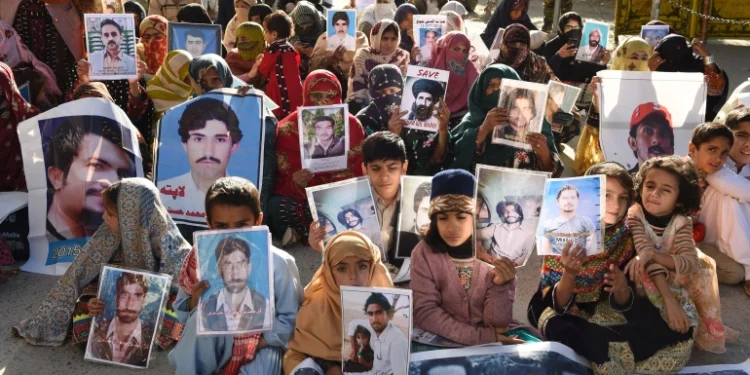 Relatives of missing Pakistanis hold pictures of their loved ones in a demonstration during Human Rights Day in Quetta, the capital of Balochistan province, on December 10, 2018
