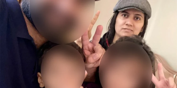 Shari Baloch with her husband and children whose faces have been blurred [Courtesy of Haibatan Baloch]